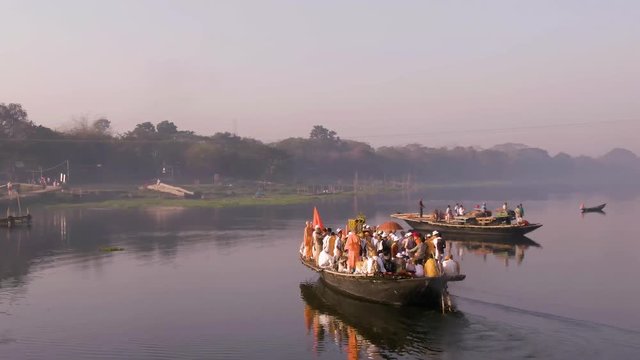 Hare Krishna pilgrims procession in a boat, Mayapur, India, 4k aerial 