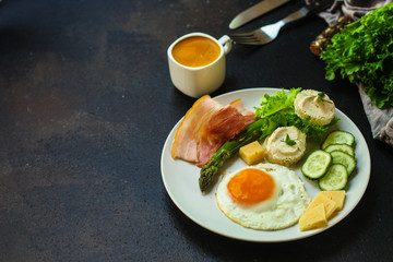 healthy food - breakfast (scrambled eggs, bacon, lettuce, asparagus, cucumbers, cheese, sandwich). food background. top view. copy space