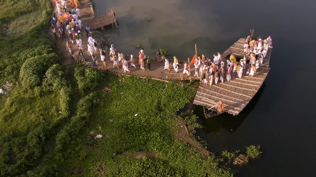 Hare Krishna pilgrims procession in a boat, Mayapur, India, 4k aerial 