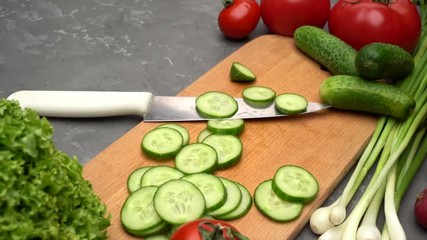 Sliced cucumber on the wooden desk. Vegetables and healthy food concept