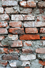 Old brick wall, old texture of red stone blocks closeup.