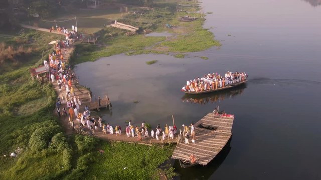 Hare Krishna pilgrims procession in a boat, Mayapur, India, 4k aerial 