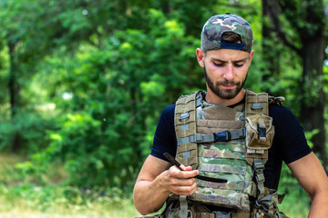 Military guy shaves in the field.