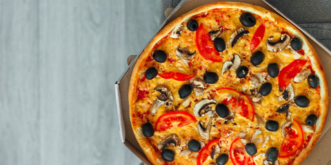 pizza, mushrooms, olives, chicken, tomato sauce, cheese, (pizza ingredients). hot pizza. Top view. copy space