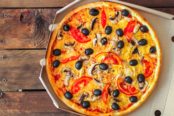 pizza, mushrooms, olives, chicken, tomato sauce, cheese, (pizza ingredients). hot pizza. Top view. copy space
