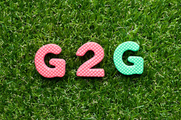 Toy foam letter in word G2G (abbreviation of Government to government)  on green grass background