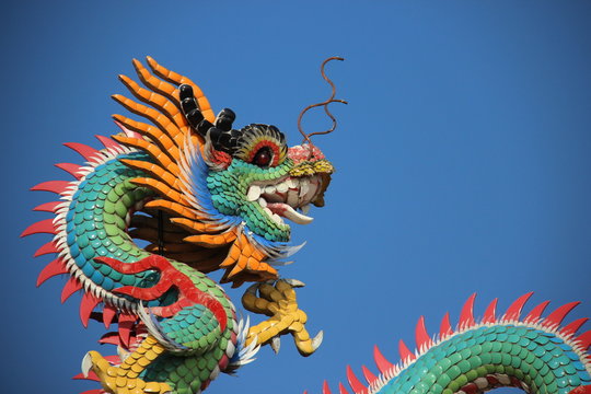 fantasy Animals. One  Multicolored Ceramic Dragon Decoration On Shrine Roof
