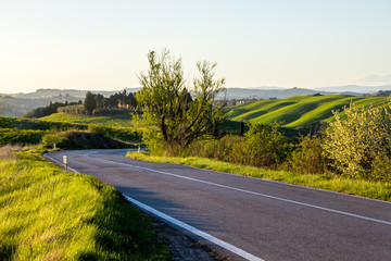 sunrise over a fields and hills in Tuscany