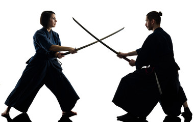 caucasian man and woman practicing laido Katori Shinto ryu isolated shadow silhouette on white...