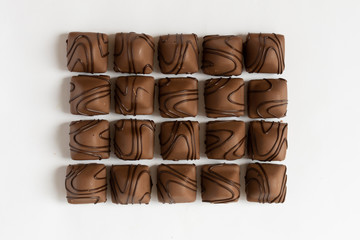Chocolate candy on white background. Chocolate truffle sweets closeup.