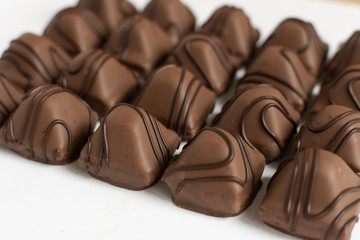 Chocolate candy on white background. Chocolate truffle sweets closeup.