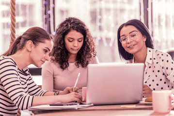 Three master students feeling busy while working on their project assignment