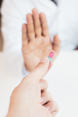 Patient refusing to use medication . Doctor or pharmacist giving pills