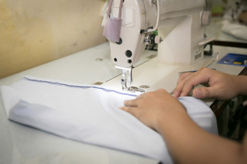 Closeup, Tailor working cutting fabric to a new coat with textile