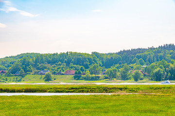 View over the Elbauen in Lower Saxony, Germany. You see a landscape with meadows, trees and the river Elbe.