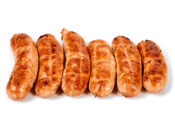 Meat sausages with glitter on a light background. Fried sausage. The concept of traditional cuisine.