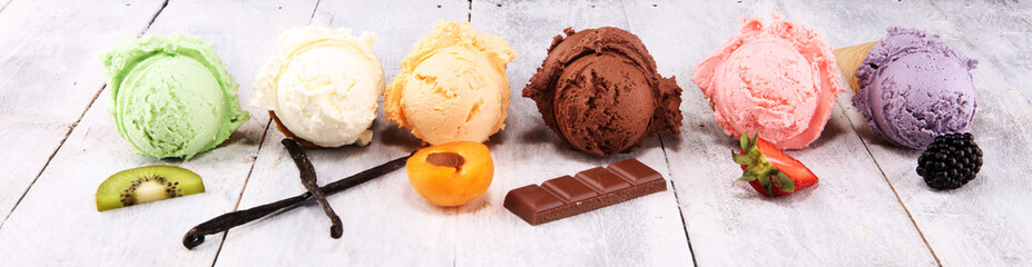 ice cream scoops of different colors and flavours with berries, nuts and fruits decoration on white background