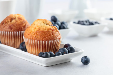 Muffins and blueberry on white table.