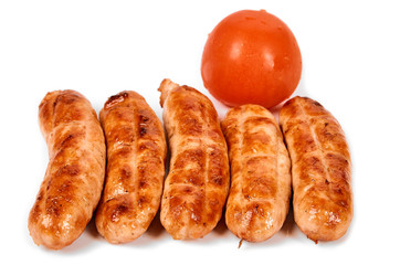 Meat sausages with glitter on a light background. Fried sausage. The concept of traditional cuisine.