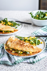 Potato rosti with corn and rocket salad served on a gray background. Traditional swiss dish