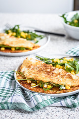 Potato rosti with corn and rocket salad served on a gray background. Traditional swiss dish