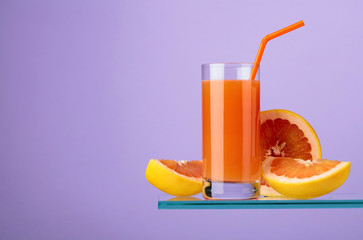 Glass of fresh grapefruit juice with fresh fruits.
