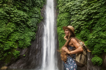 Woman near Munduk waterfal on Bali, Indonesia