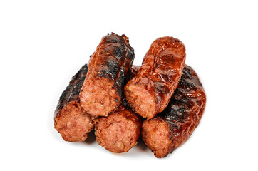 Meat sausages with glitter on a light background. Fried sausage. The concept of traditional cuisine.