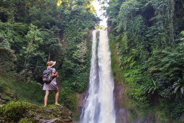 Woman near waterfal Git Git on Bali, Indonesia 