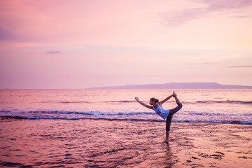 Caucasian woman practicing yoga at seashore