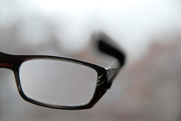 close-up on reading glasses with diffuse background