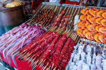 Roasted and raw insects, silkworms, scorpions, bugs, snakes, shrimps, dog meat, octopus on stick