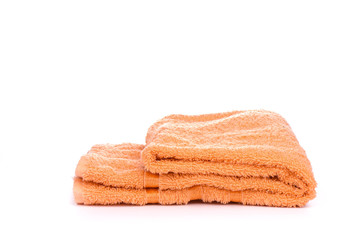 Orange terry towel isolated on a white background.