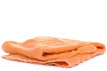 Fototapeta na wymiar Orange terry towel isolated on a white background.