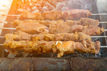 Skewers with meat kebabs on the grill with smoke	