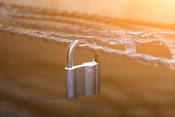 Metal lock, latched on a metal decorative forged lattice. Concept