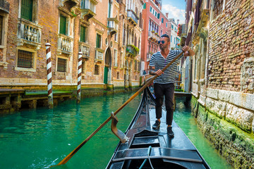 Gondolier on canal of venice