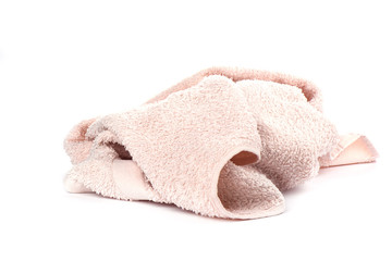 Light pink terry towel isolated on white background.