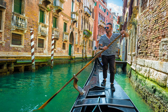Gondolier on canal of venice