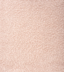 The texture of the fabric is light pink terry towel. Terry cloth as a background.