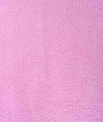 The texture of the fabric is pink terry towel. Terry cloth as a background.