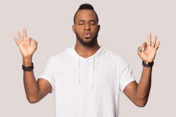 Stressed african guy exhales and calms down studio shot