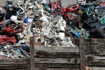 old cars and scrap metal waiting for recyling at junkyard