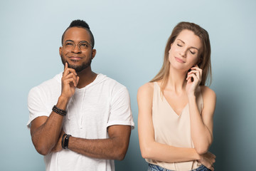 Diverse thoughtful millennial family couple dreaming together.