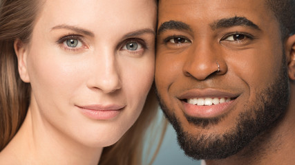 Headshot portrait of smiling diverse family couple.