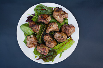 Barbecue meat .Meat on skewers. View from above. Dark background.