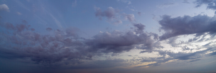 Panoramic view of evening sky with clouds, the sky at twilight.