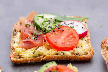 Sandwiches with cream cheese, vegetables and salami.
