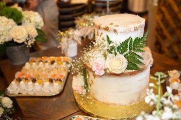 Delicious decorated cake at festive dessert party table