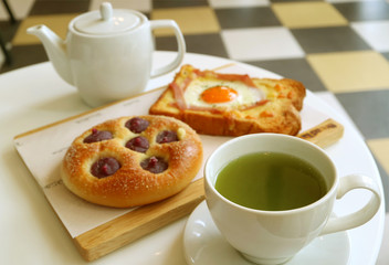 Delicious Breakfast of Hot Green Tea with Baked Toast and Bun